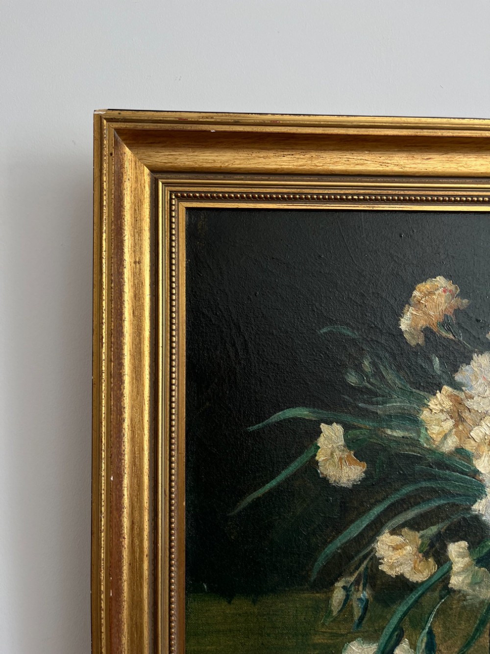 A horizontal oil painting depicting a bouquet of red, pink, yellow, and white carnations in a dark vase, enclosed within a moulded gilt frame. View XIII