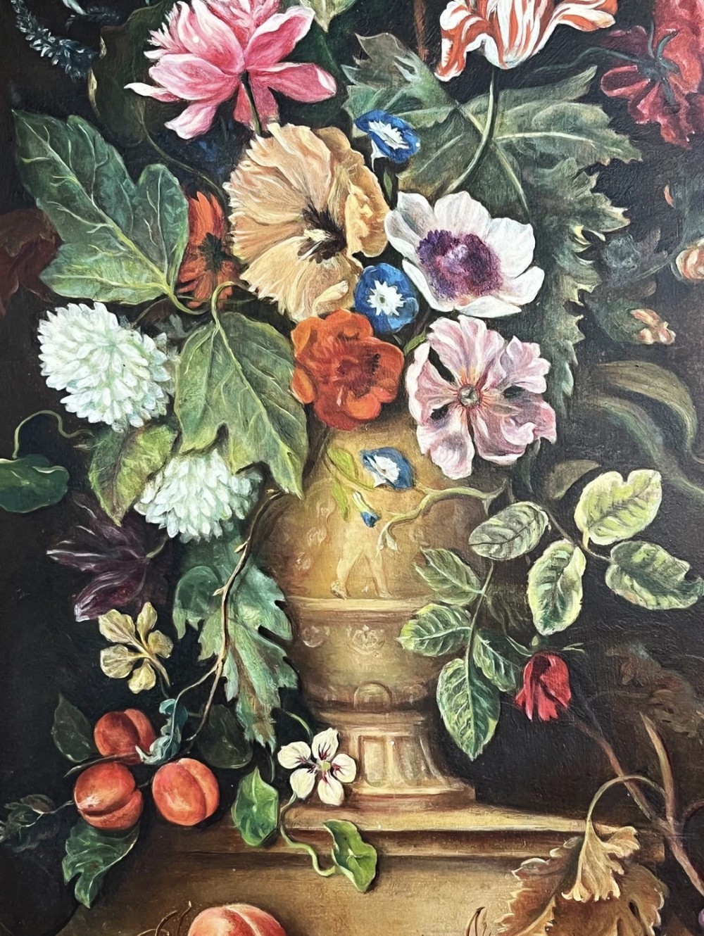 A framed oil painting depicting a floral arrangement in a urn with fruit at the base, housed within an ornate gilt gesso frame. View VII