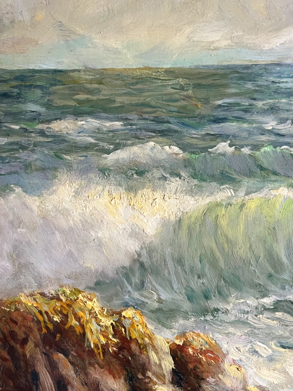 A framed oil painting depicting crashing ocean waves against coastal rocks under an overcast sky, signed by artist Sidney A. Court. View XII
