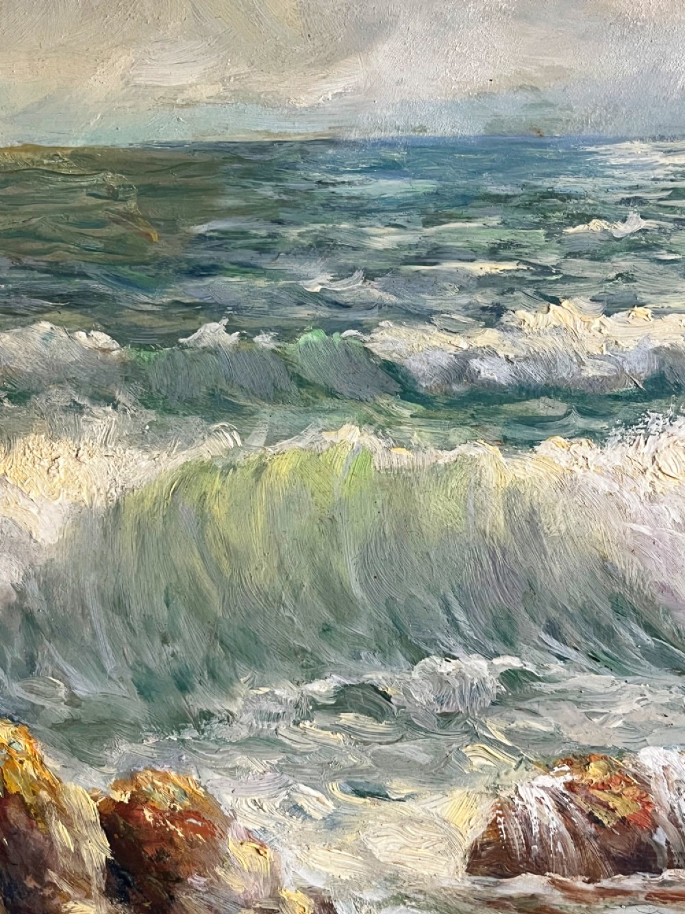 A framed oil painting depicting crashing ocean waves against coastal rocks under an overcast sky, signed by artist Sidney A. Court. View XIII