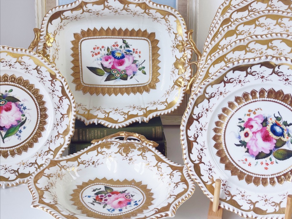 An eight-piece Regency Grainger Lee & Co porcelain dessert service with gold leaf borders and hand-painted floral centres against a white ground. View II