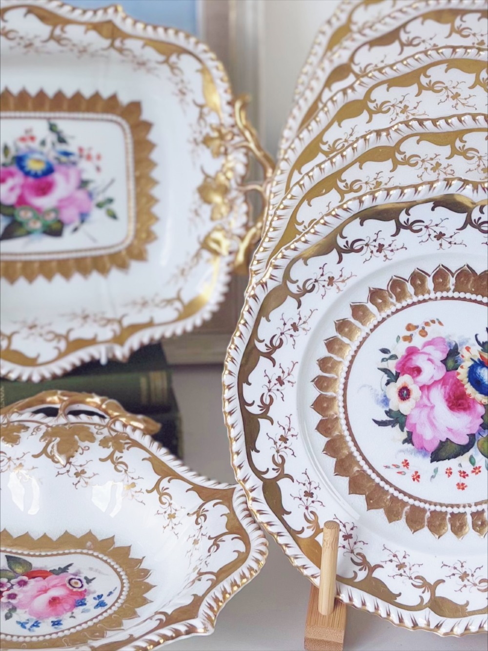 An eight-piece Regency Grainger Lee & Co porcelain dessert service with gold leaf borders and hand-painted floral centres against a white ground. View III