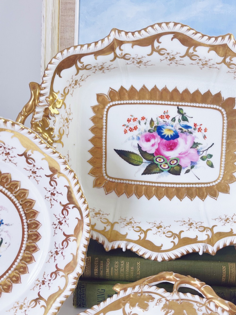 An eight-piece Regency Grainger Lee & Co porcelain dessert service with gold leaf borders and hand-painted floral centres against a white ground. View VII