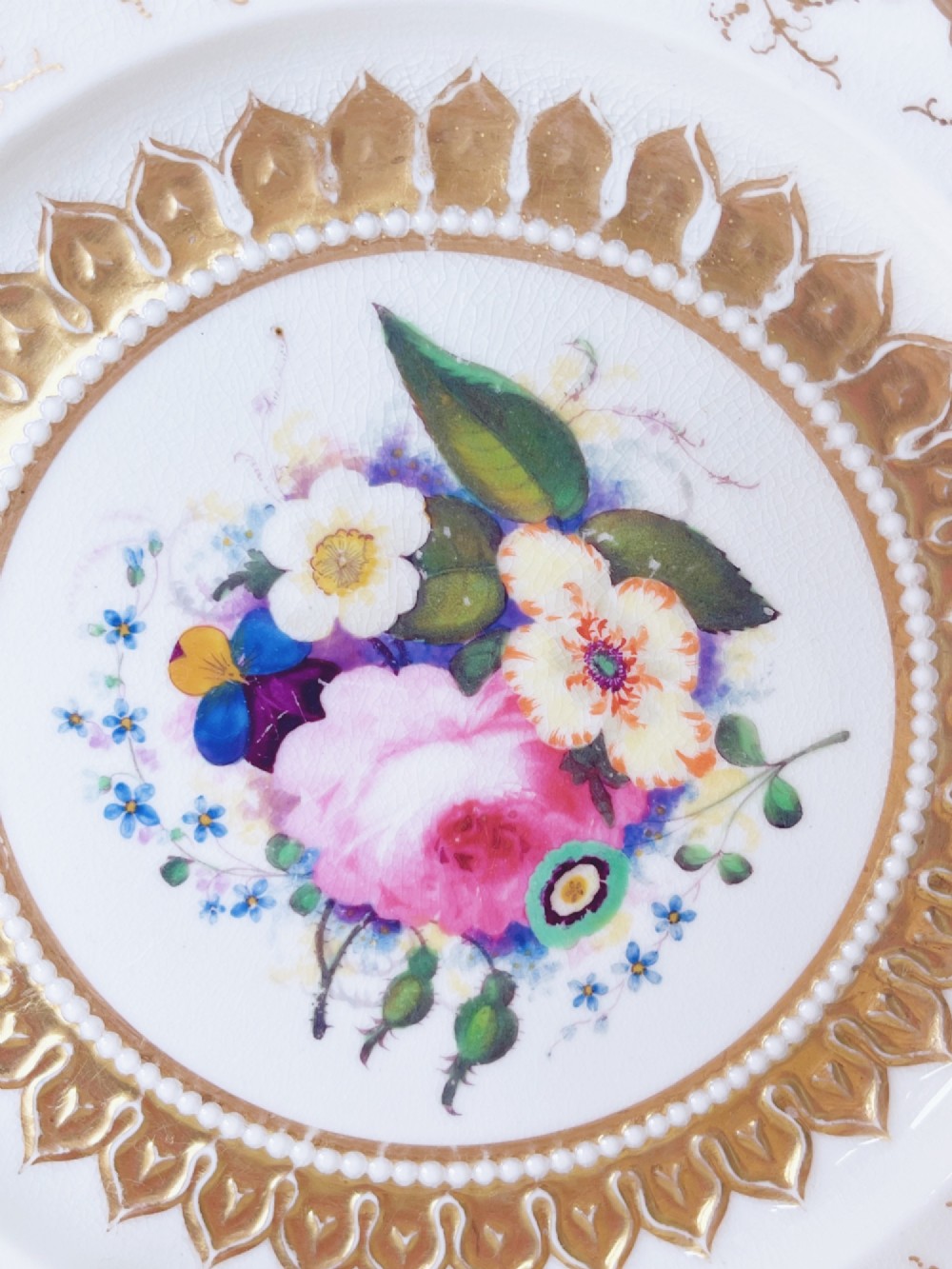 An eight-piece Regency Grainger Lee & Co porcelain dessert service with gold leaf borders and hand-painted floral centres against a white ground. View IX