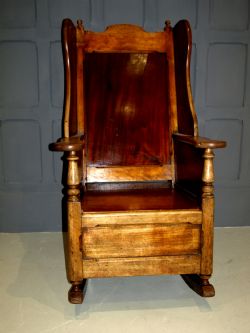 A RARE EARLY 18TH CENTURY GENTLEMAN'S WINGED BACKED MAHOGANY ROCKING CHAIR