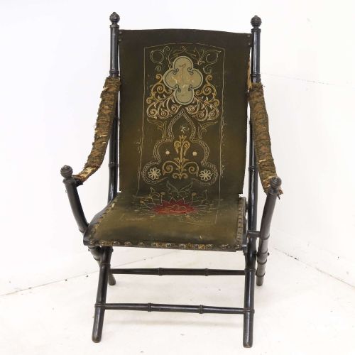 fig 1. A 19th-century French Louis Philippe folding campaign chair featuring an ebonised faux-bamboo frame and an embroidered dark green fabric sling back and seat.