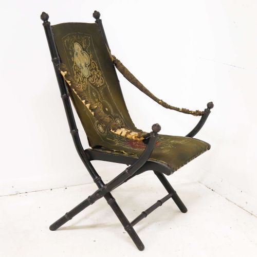 fig 2. A 19th-century French Louis Philippe folding campaign chair featuring an ebonised faux-bamboo frame and an embroidered dark green fabric sling back and seat.