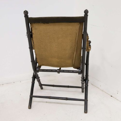 fig 3. A 19th-century French Louis Philippe folding campaign chair featuring an ebonised faux-bamboo frame and an embroidered dark green fabric sling back and seat.