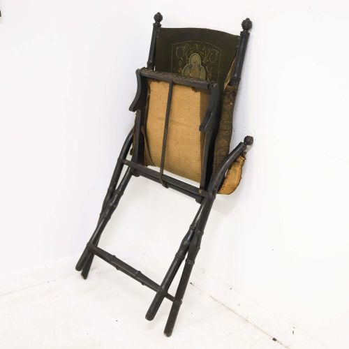 fig 4. A 19th-century French Louis Philippe folding campaign chair featuring an ebonised faux-bamboo frame and an embroidered dark green fabric sling back and seat.