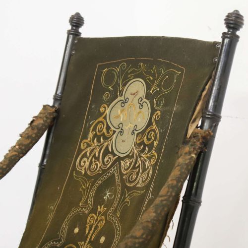 fig 6. A 19th-century French Louis Philippe folding campaign chair featuring an ebonised faux-bamboo frame and an embroidered dark green fabric sling back and seat.