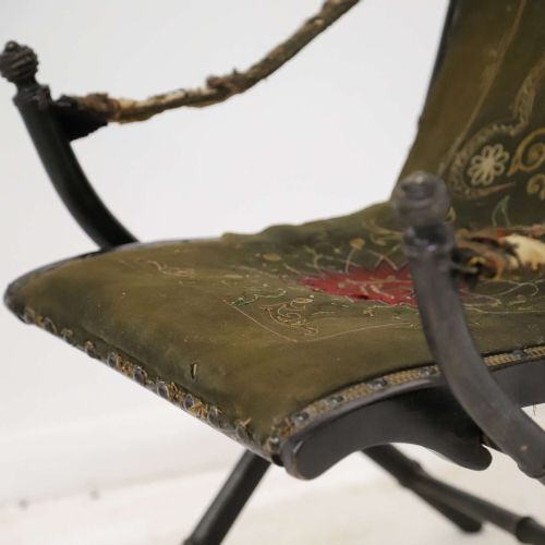 fig 9. A 19th-century French Louis Philippe folding campaign chair featuring an ebonised faux-bamboo frame and an embroidered dark green fabric sling back and seat.