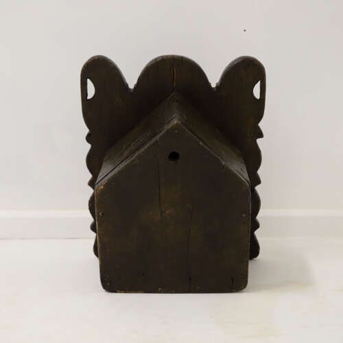 fig 8. A dark oak wall-mounted salt box featuring shaped decorative edges, a circular hanging aperture, and a hinged lid.