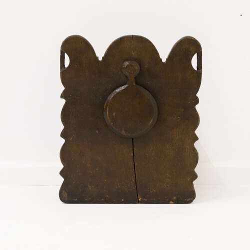 fig 10. A dark oak wall-mounted salt box featuring shaped decorative edges, a circular hanging aperture, and a hinged lid.
