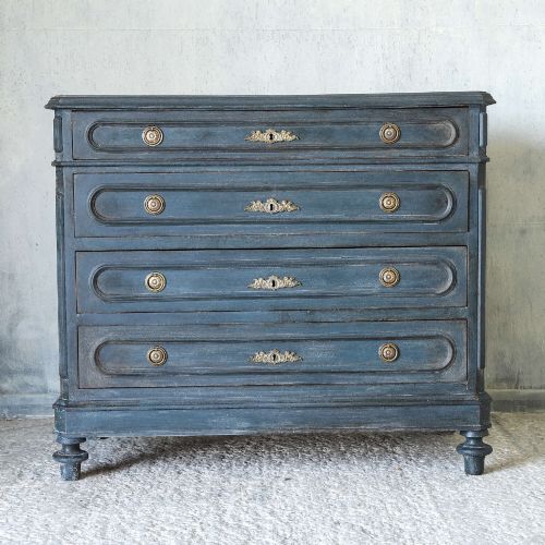 fig 1. A late 19th-century French Louis XVI Revival chest of drawers painted in slate blue with four drawers featuring decorative brass hardware.