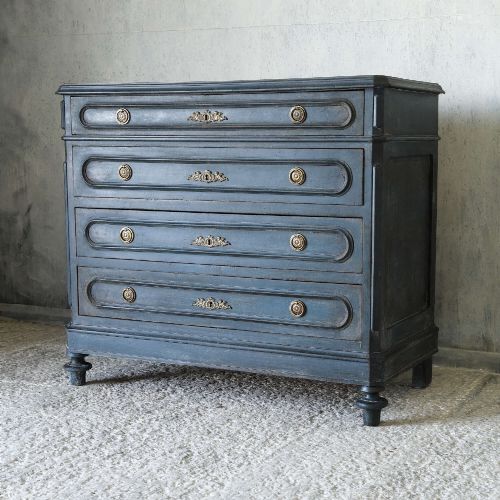fig 2. A late 19th-century French Louis XVI Revival chest of drawers painted in slate blue with four drawers featuring decorative brass hardware.