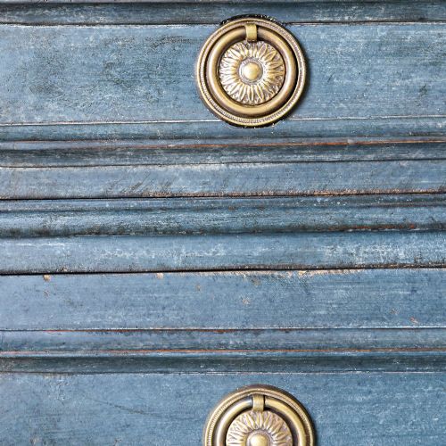 fig 5. A late 19th-century French Louis XVI Revival chest of drawers painted in slate blue with four drawers featuring decorative brass hardware.