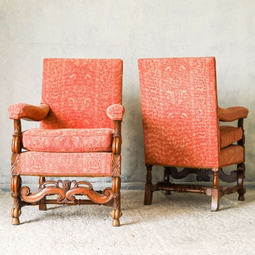 fig 1. A pair of late nineteenth-century French Renaissance Revival oak armchairs upholstered in terracotta patterned fabric with carved scrolled stretchers and turned legs.