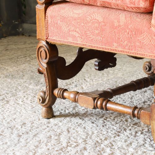 fig 7. A pair of late nineteenth-century French Renaissance Revival oak armchairs upholstered in terracotta patterned fabric with carved scrolled stretchers and turned legs.
