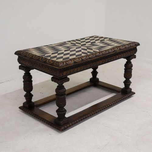fig 2. A 19th-century carved oak centre table featuring turned baluster legs, a stretcher base, and a geometric black and white painted starburst top.