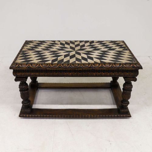 fig 3. A 19th-century carved oak centre table featuring turned baluster legs, a stretcher base, and a geometric black and white painted starburst top.
