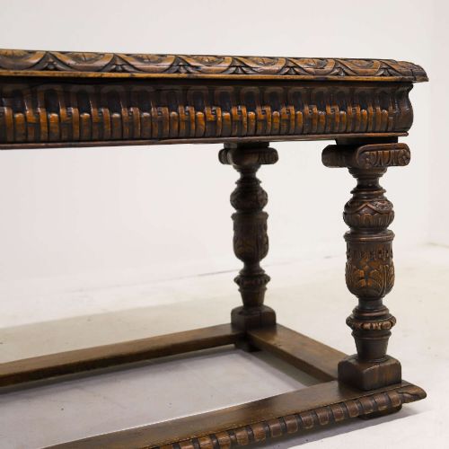 fig 5. A 19th-century carved oak centre table featuring turned baluster legs, a stretcher base, and a geometric black and white painted starburst top.