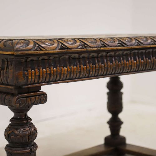 fig 6. A 19th-century carved oak centre table featuring turned baluster legs, a stretcher base, and a geometric black and white painted starburst top.