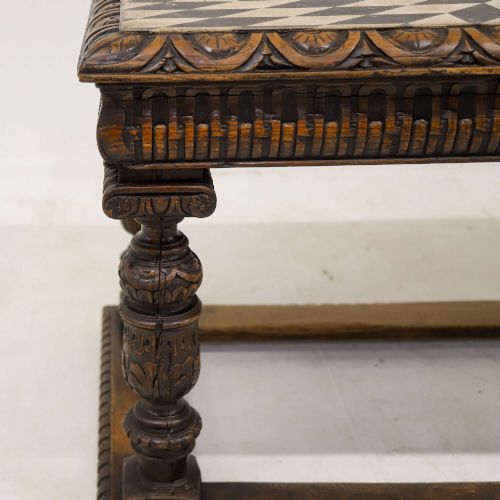 fig 7. A 19th-century carved oak centre table featuring turned baluster legs, a stretcher base, and a geometric black and white painted starburst top.