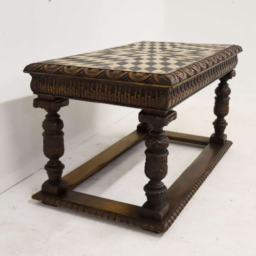 fig 11. A 19th-century carved oak centre table featuring turned baluster legs, a stretcher base, and a geometric black and white painted starburst top.