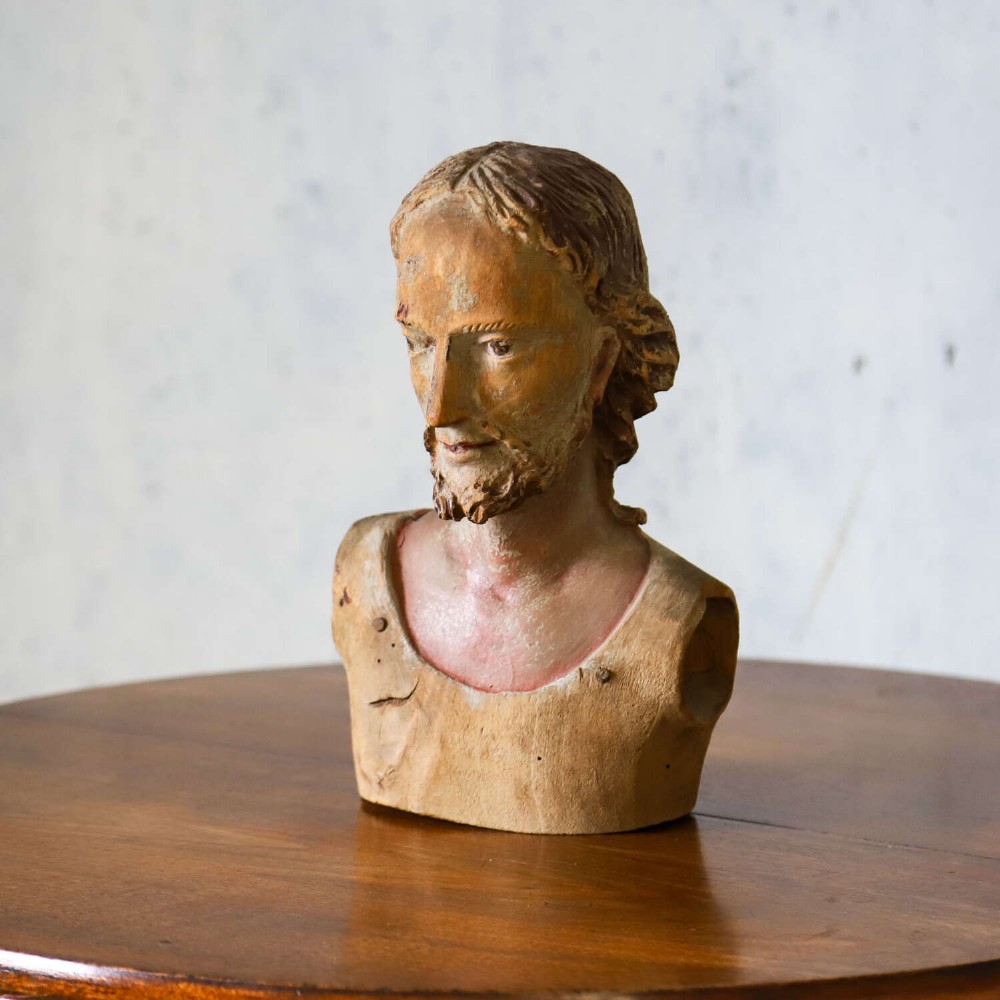 An 18th-century carved olive wood bust depicting Christ with visible traces of original polychrome paint. View III