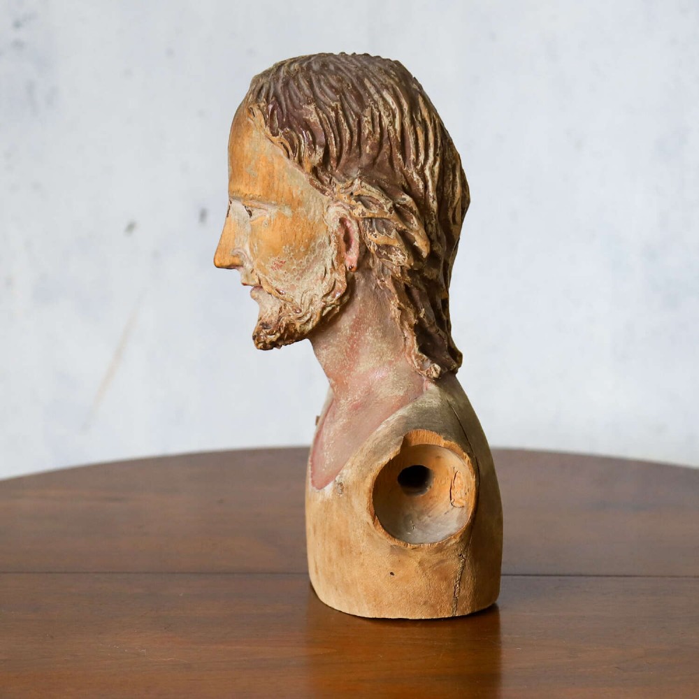 An 18th-century carved olive wood bust depicting Christ with visible traces of original polychrome paint. View VI
