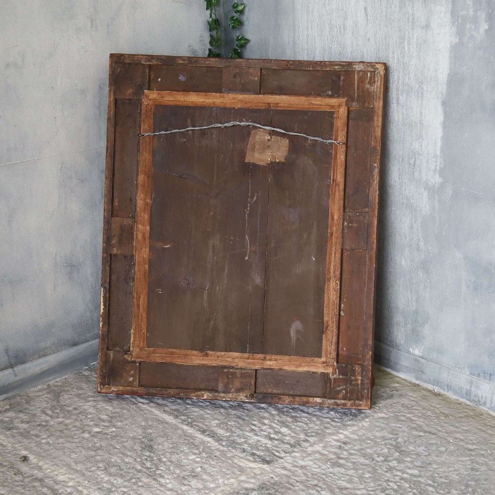 An early 19th-century rectangular wall mirror featuring an ornate gold gilded frame with scrollwork moulding and heavily foxed glass. View IX