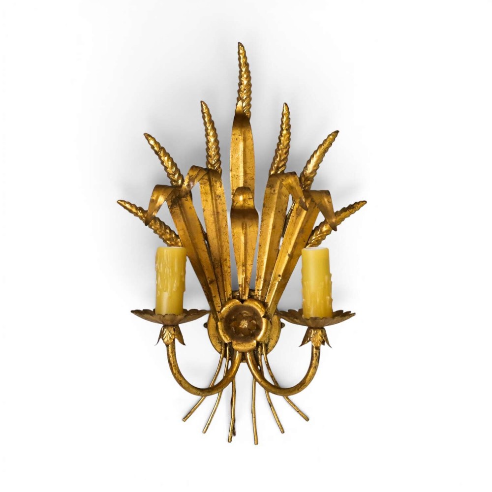 A mid-century gilt metal wall sconce crafted in the form of a wheat sheaf with two candle arms.
