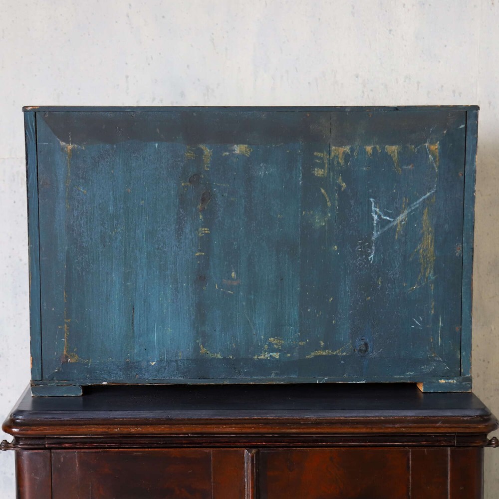 A glazed wooden shadow box containing a three-dimensional diorama of a four-masted sailing ship and a steam barge against a painted blue background. View XII