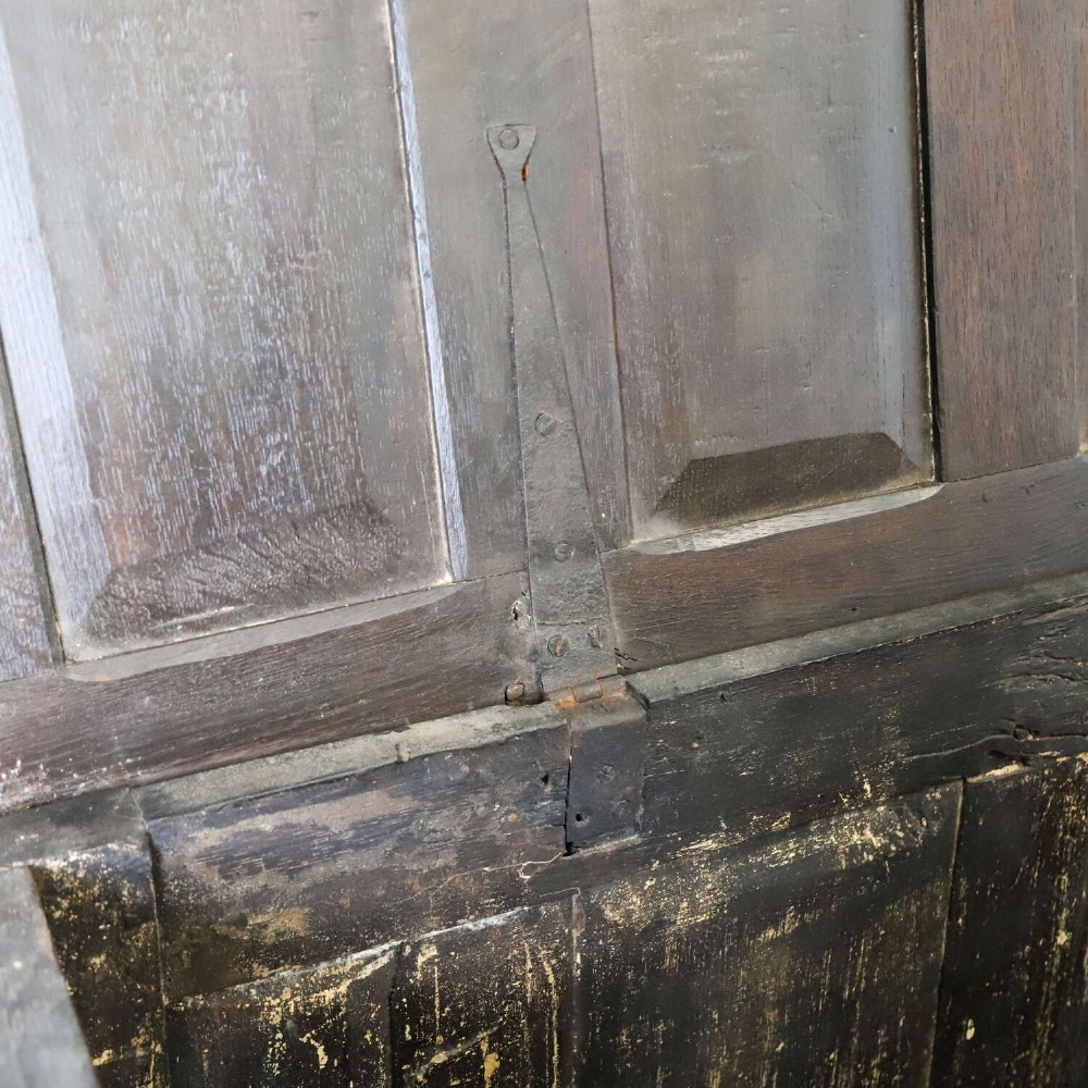 A dark oak coffer featuring four hand-carved Gothic arch panels, a fluted frieze, and a sturdy four-panel hinged lid. View X