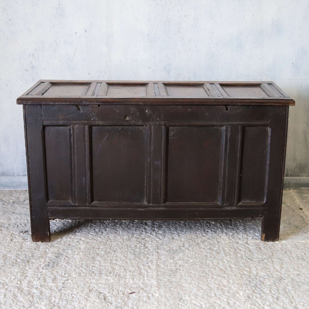 A dark oak coffer featuring four hand-carved Gothic arch panels, a fluted frieze, and a sturdy four-panel hinged lid. View XII