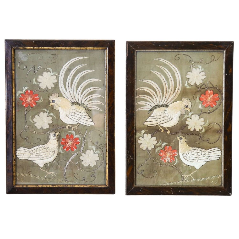 A pair of rectangular 19th-century French silk embroideries featuring cockerels, hens, and red flowers on a sage green background, set in dark faux tortoiseshell frames with gilt inner borders.