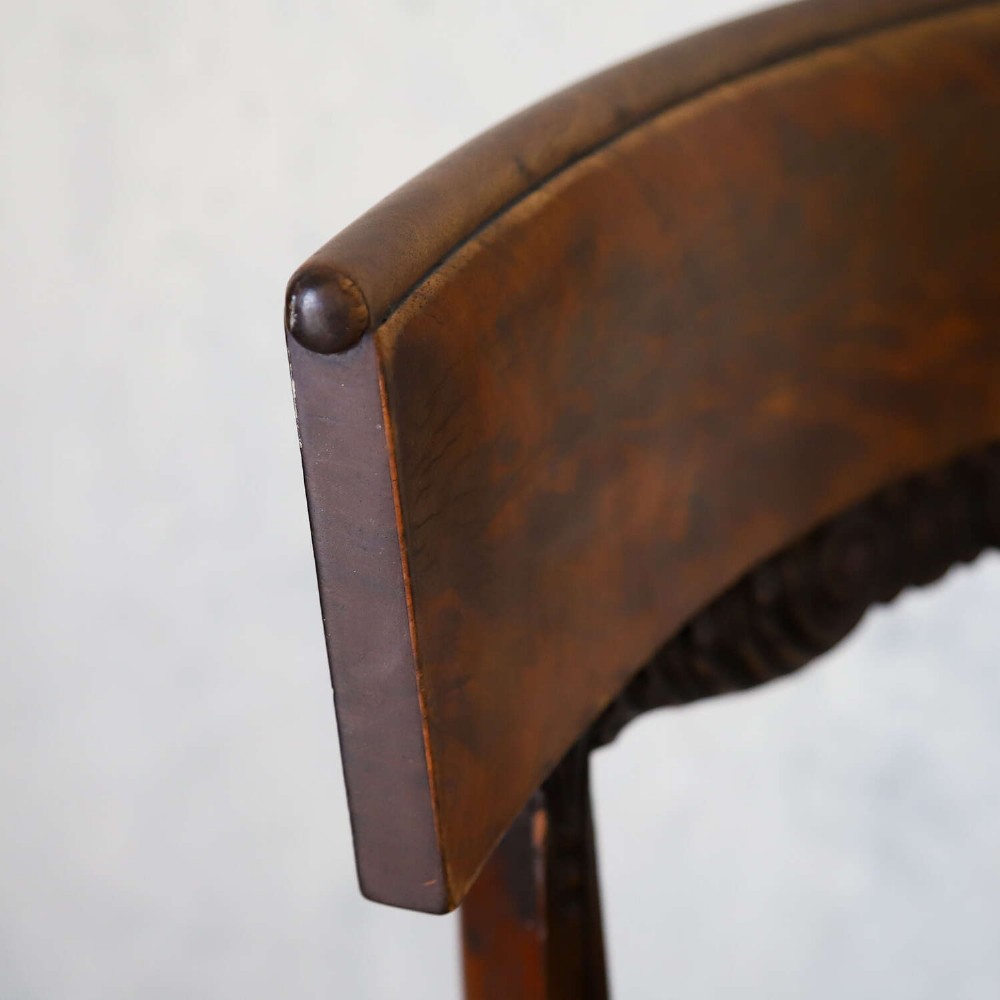 A pair of William IV mahogany side chairs featuring curved top rails with relief carving, fluted front legs, and seats upholstered in green and gold striped fabric. View IX