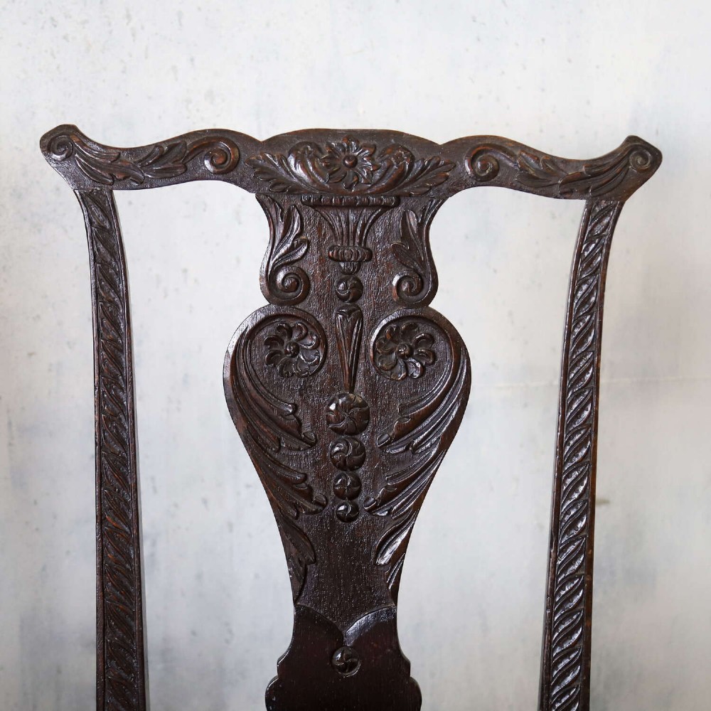 A pair of dark carved oak side chairs with vasiform splats and seats upholstered in red and gold patterned velvet. View IV
