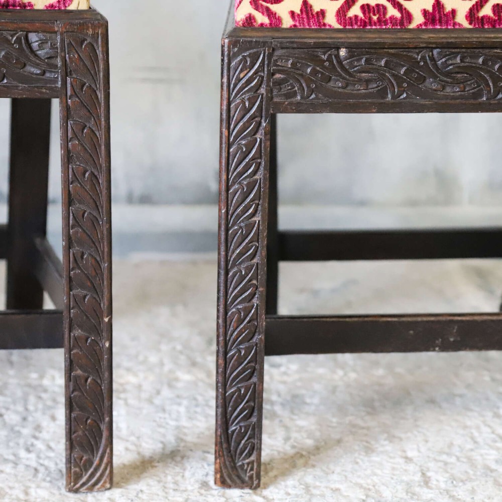 A pair of dark carved oak side chairs with vasiform splats and seats upholstered in red and gold patterned velvet. View VI