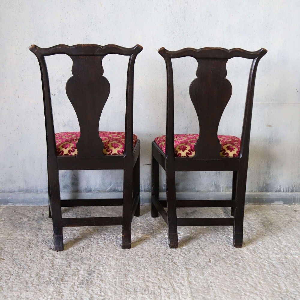A pair of dark carved oak side chairs with vasiform splats and seats upholstered in red and gold patterned velvet. View VIII