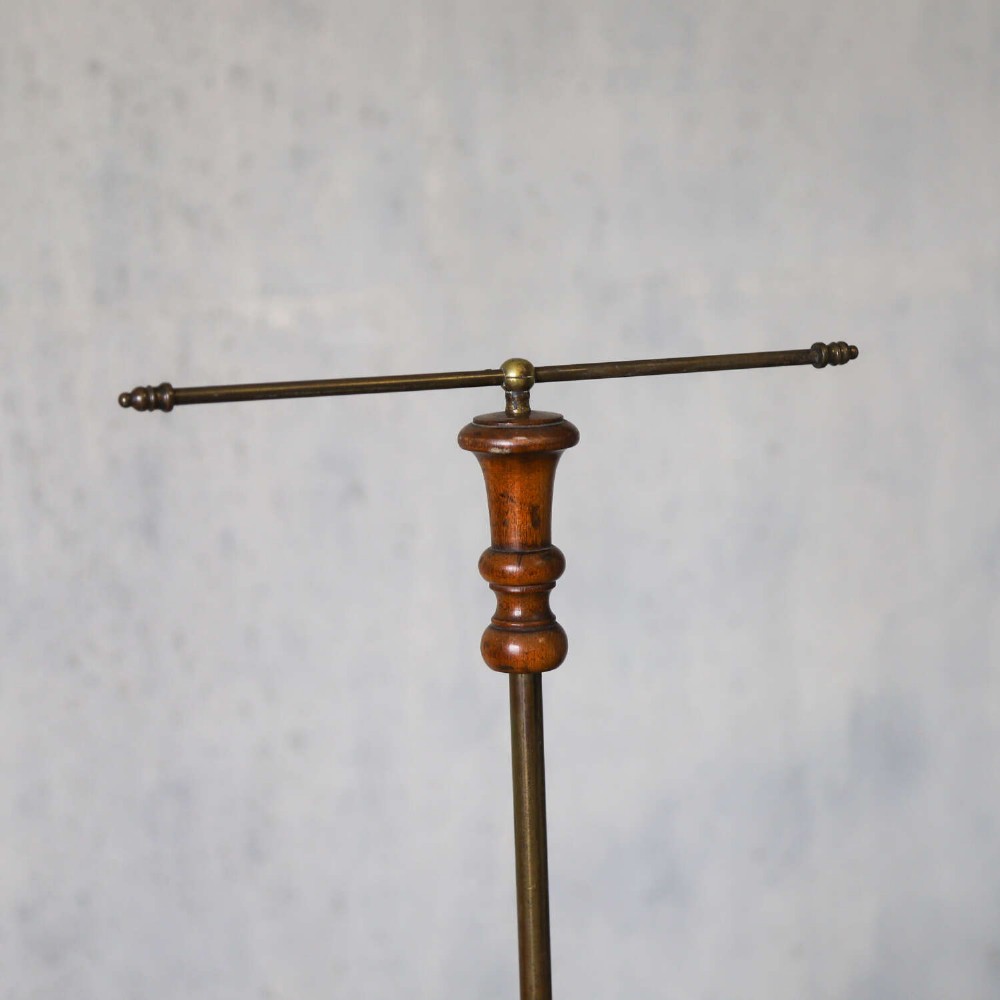 A four-tiered Victorian cotton reel display tree featuring circular wooden tiers with vertical metal spindles set on a cast iron base. View III