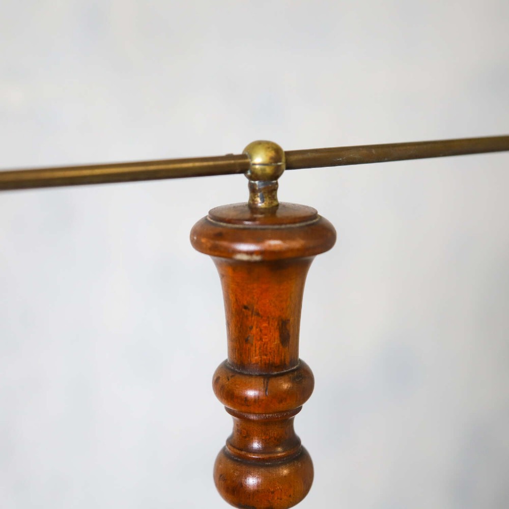 A four-tiered Victorian cotton reel display tree featuring circular wooden tiers with vertical metal spindles set on a cast iron base. View XI