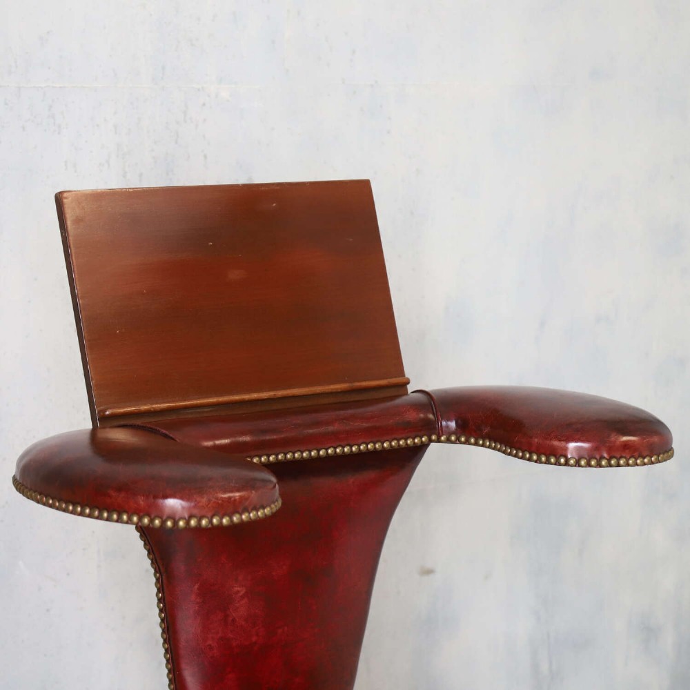 A late Victorian Sheraton style reading chair upholstered in burgundy red leather with brass studding and mahogany legs. View VII
