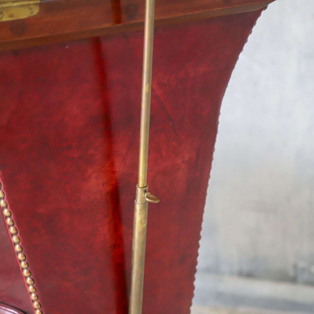 A late Victorian Sheraton style reading chair upholstered in burgundy red leather with brass studding and mahogany legs. View XII