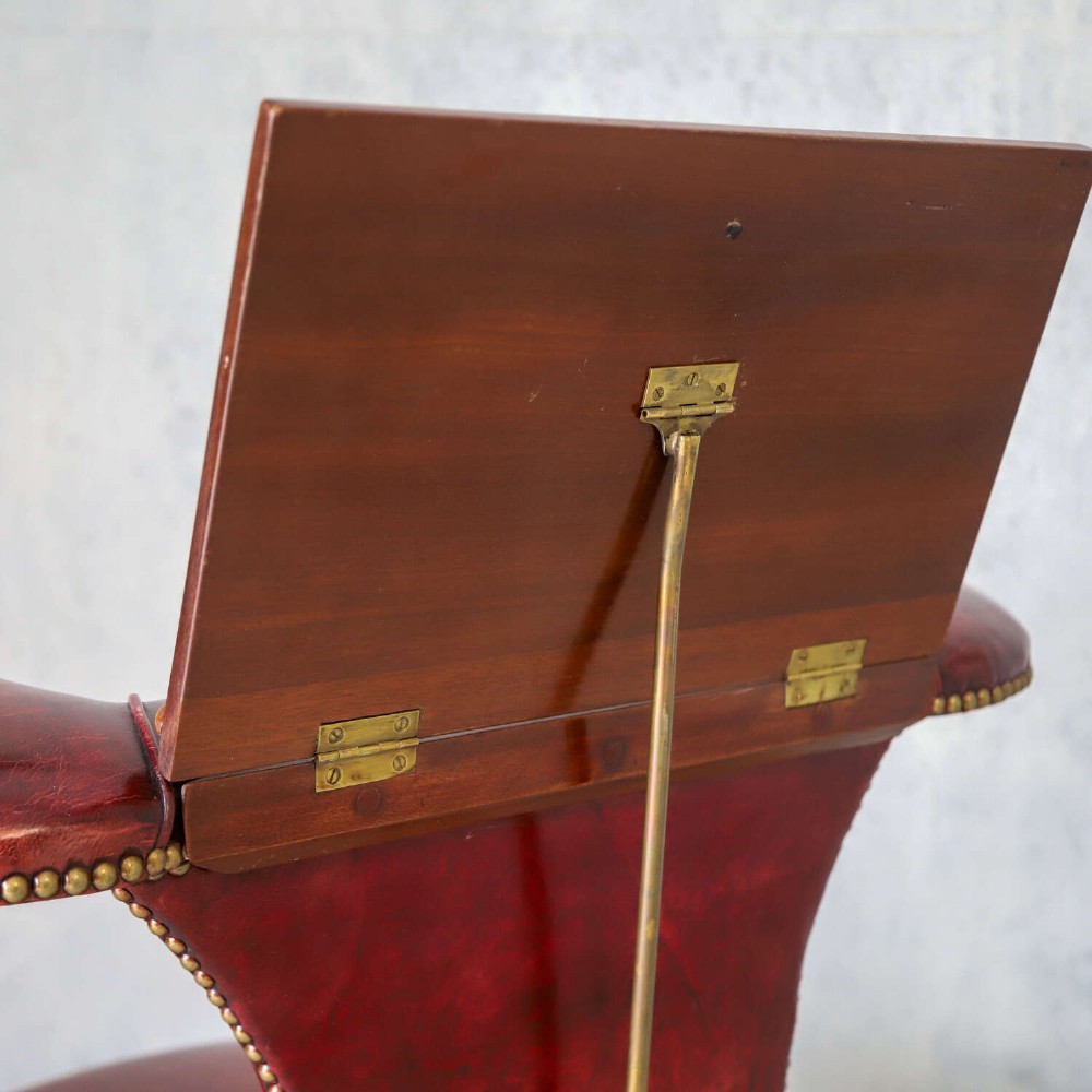A late Victorian Sheraton style reading chair upholstered in burgundy red leather with brass studding and mahogany legs. View XIII