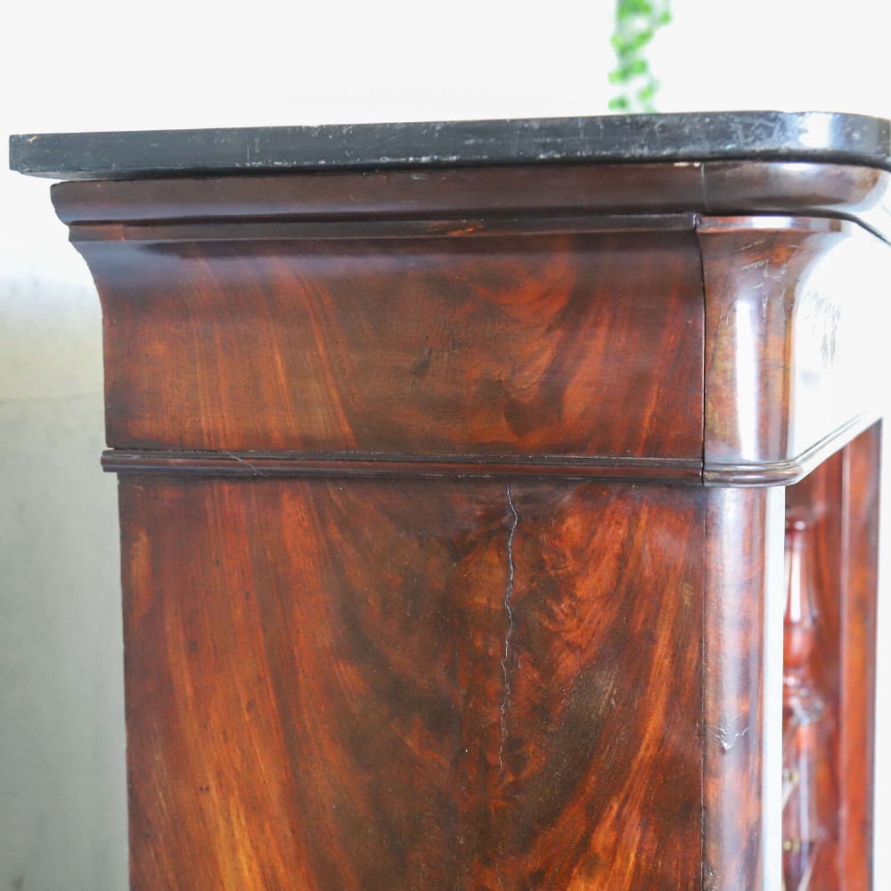 A 19th-century French secretaire a abattant featuring flame mahogany veneers, a dark marble top slab, an upper drop-front writing panel, and lower cupboard doors. View VIII