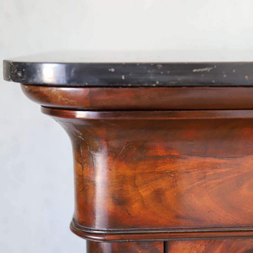 A 19th-century French secretaire a abattant featuring flame mahogany veneers, a dark marble top slab, an upper drop-front writing panel, and lower cupboard doors. View XI