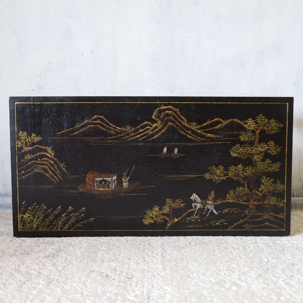 A low rectangular black japanned coffee table decorated with hand-painted gilt landscape scenes and supported by straight legs. View II