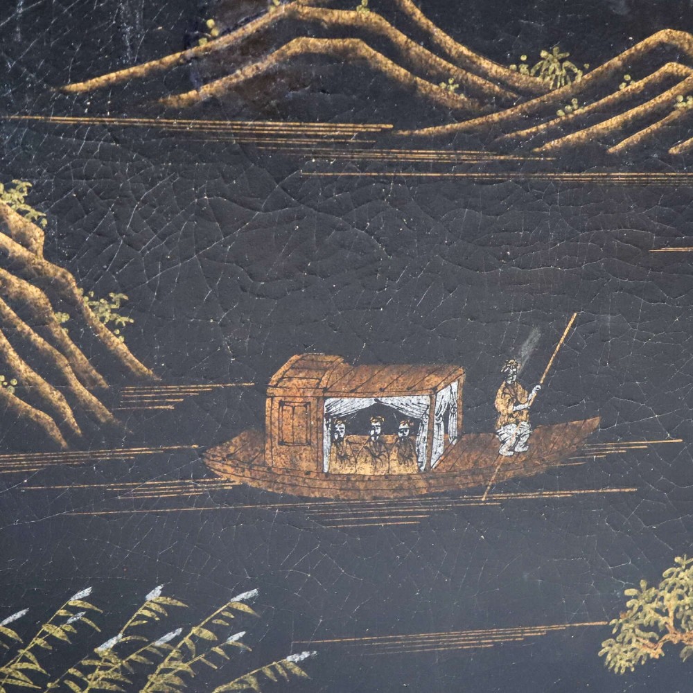 A low rectangular black japanned coffee table decorated with hand-painted gilt landscape scenes and supported by straight legs. View IV
