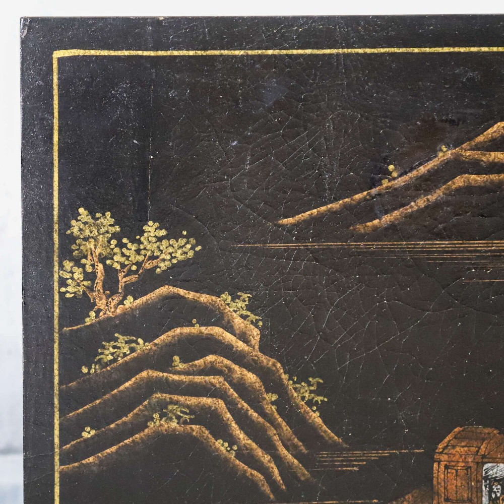 A low rectangular black japanned coffee table decorated with hand-painted gilt landscape scenes and supported by straight legs. View VI